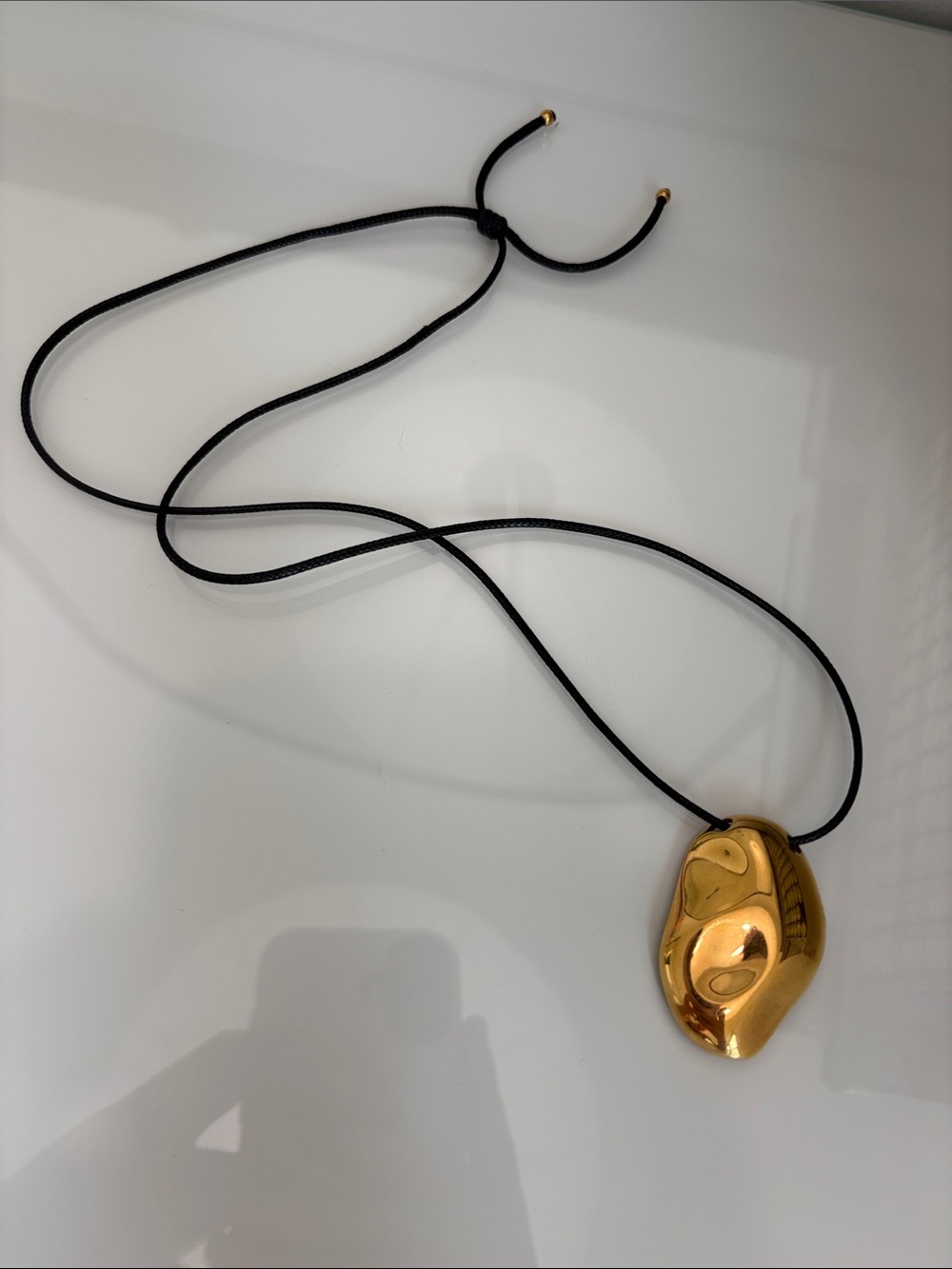 Gold Sculpted Pendant Necklace on Black Cord
